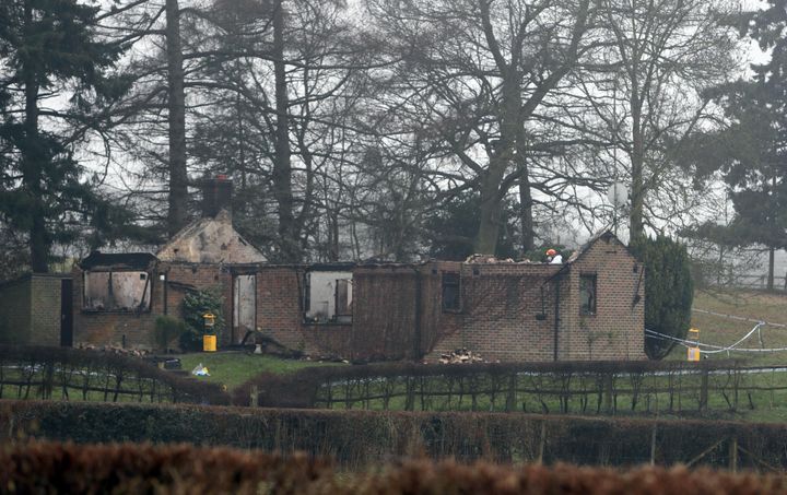 The scene in Trumpets Hill Road in Reigate, Surrey where the bodies of two adults and a child have been discovered