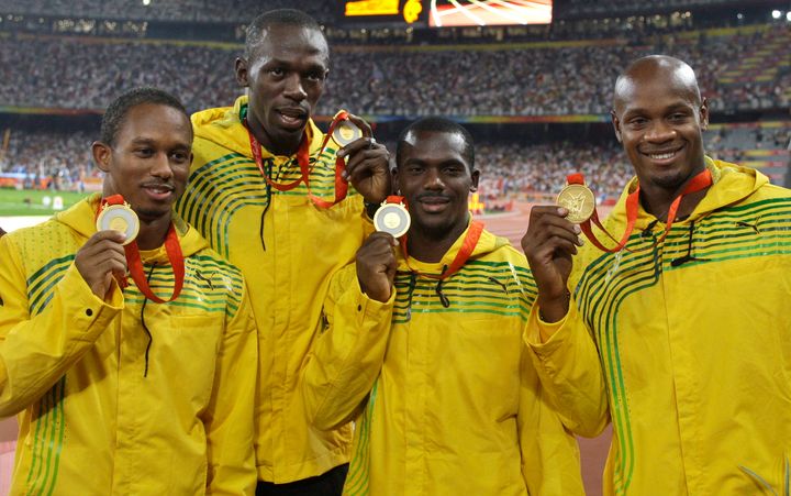 (L to R) Michael Fraser, Usain Bolt, Nesta Carter and Asafa Powell with their gold medals at the 2008 games