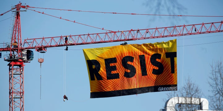 Greenpeace activists urge the public to resist the presidency of Donald Trump.