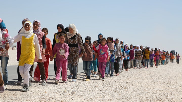 <p>Syrian children march in the refugee camp in Jordan</p>
