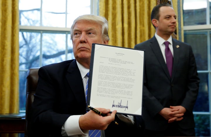 President Donald Trump holds up the executive order on the reinstatement of the Mexico City policy, Jan. 23, 2017. If history is any indication, it will result in even more abortions and maternal deaths worldwide.