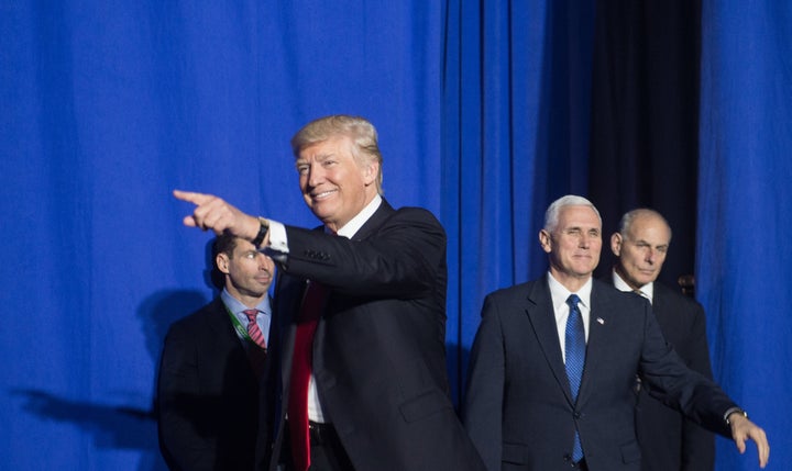 President Donald Trump arrives to speak to staff of the Department of Homeland Security in Washington, D.C., on Wednesday. He's followed by Vice President Mike Pence and Homeland Security Secretary John Kelly.