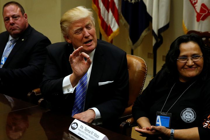 President Donald Trump, flanked by Gary Masino of the Sheet Metal Workers Union and Telma Mata of the Heat and Frost Insulators Allied Workers Local 24, holds a roundtable with labor leaders at the White House on Jan. 23.