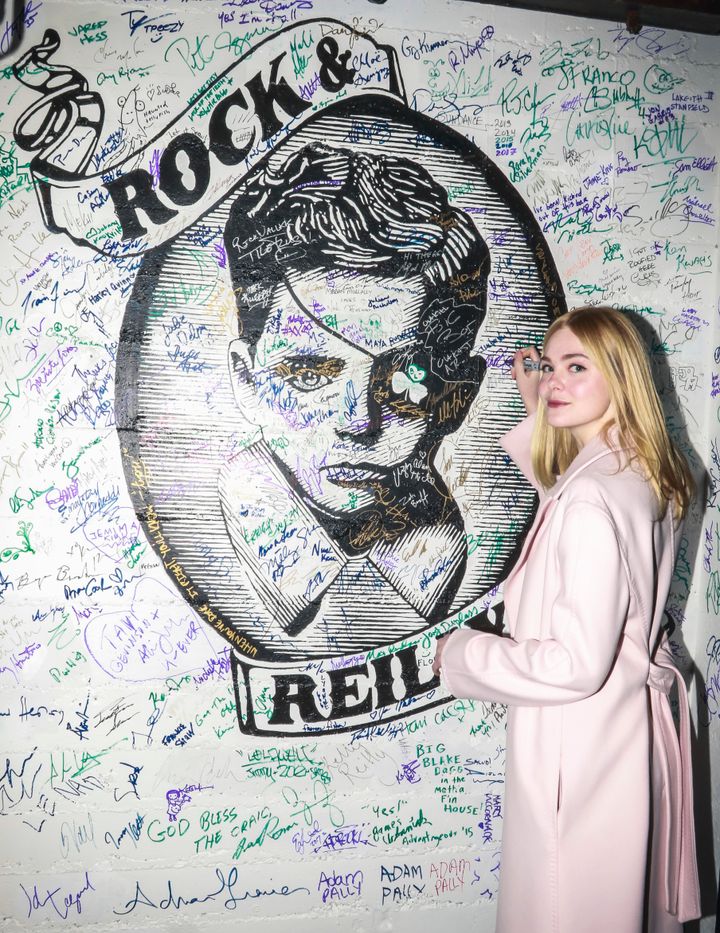 <p>Elle Fanning signing the wall at Rock & Reilly’s during the 2017 Sundance Film Festival.</p>