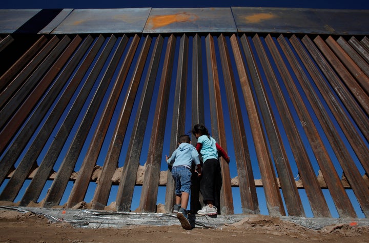 Children play at a newly built section of the U.S.-Mexico border wall at Sunland Park, U.S. opposite the Mexican border city of Ciudad Juarez, Mexico November 18, 2016.