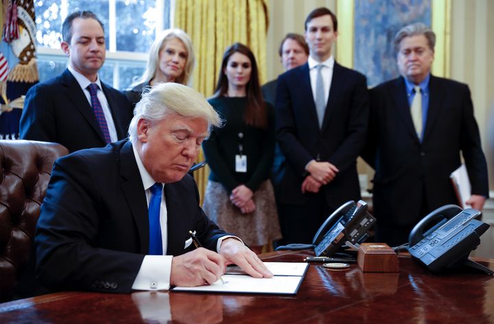 <p>Looking on as President <a href="https://www.huffpost.com/news/topic/donald-trump">Donald Trump</a> signs an executive order are White House Chief of Staff Reince Priebus, counselor to the President <a href="https://www.huffpost.com/news/topic/kellyanne-conway">Kellyanne Conway</a>, White House Communications Director Hope Hicks, Senior Advisor <a href="https://www.huffpost.com/news/topic/jared-kushner">Jared Kushner</a> and Senior Counselor Stephen Bannon.</p>