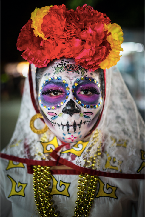 Location: Parque de las Palapas, Cancun, Mexico. "The portrait of a woman dressed in skull-candy face paint and costume to celebrate the Day of the Dead festival in Cancun’s El Parque De Las Palapas, Mexico. The festival, locally known as ‘Dia De Los Muertos’ is an annual celebration in memory of loved ones who have passed away." 