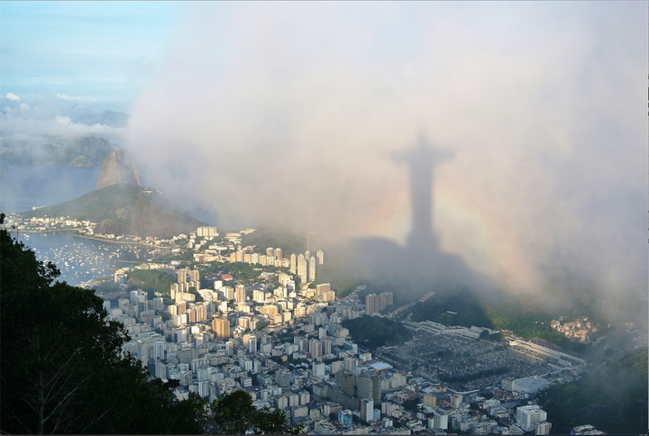 Location: Corcovado, Rio de Janeiro. "... Suddenly, the clouds parted to reveal Rio de Janeiro in all its glory and I quickly set up my camera. As light flooded across the city, I noticed the shadow of Christ the Redeemer fill my frame and quickly took a series of shots, as a rainbow briefly gave the statue its own halo." 