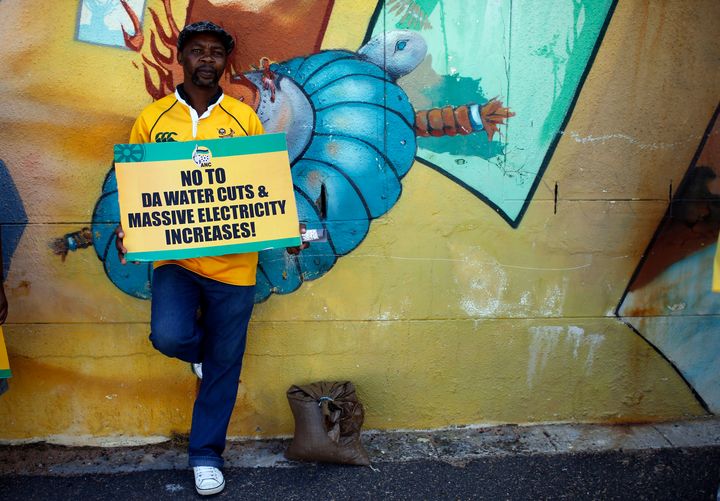 A supporter of President Jacob Zuma's ruling African National Congress awaits a march on the headquarters of the opposition Democratic Alliance in Cape Town, on Feb. 5, 2014. 