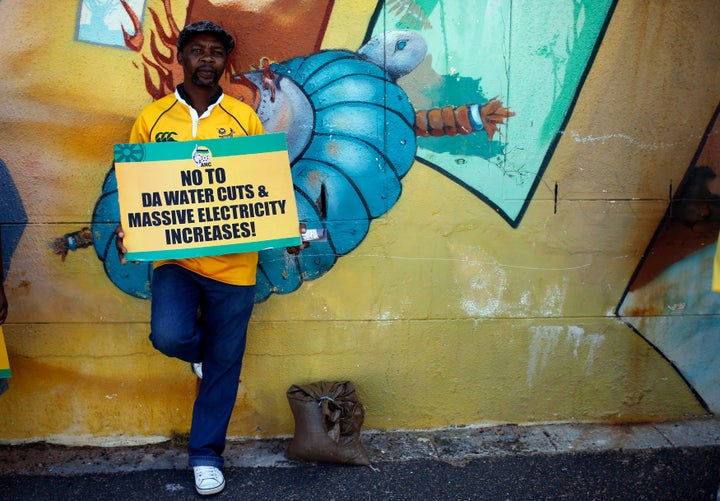 A supporter of President Jacob Zuma's ruling African National Congress awaits a march on the headquarters of the opposition D
