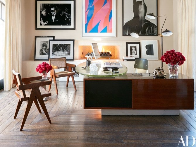 Two of Kourtney Kardashian’s v-leg armchairs by Pierre Jeanneret, seen here in her home office in Calabasas, California.