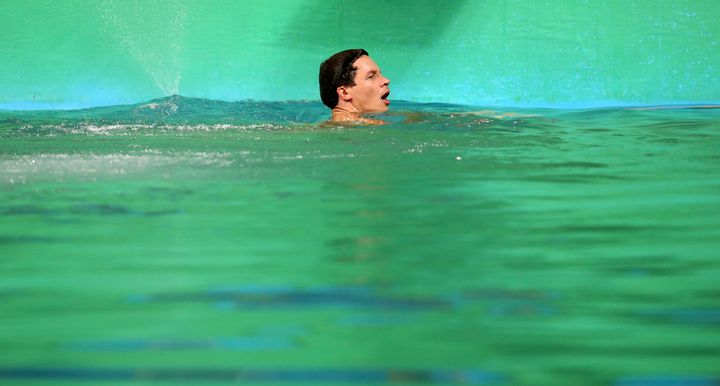 Patrick Hausding of Germany swims in the green water of the diving pool at the Maria Lenk Aquatics Centre, Rio de Janeiro, Aug. 13, 2016.