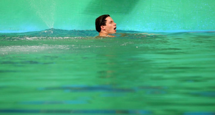 Patrick Hausding of Germany swims in the green water of the diving pool at the Maria Lenk Aquatics Centre, Rio de Janeiro, Au