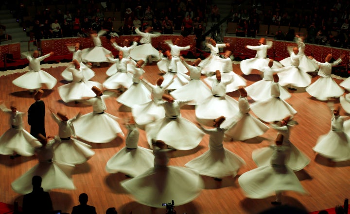 Whirling dervishes perform a traditional "Sema" ritual during a ceremony, one of many marking the 743rd anniversary of the death of Mevlana Jalaluddin Rumi, at Mevlana Cultural Center in Konya, Turkey, December 7, 2016.