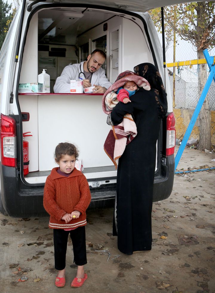 A pharmacist dispenses medicines to Syrian refugees at a camp near Taalabaya in the Bekaa Valley