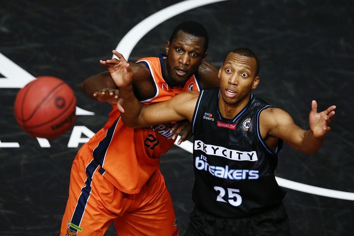 Akil Mitchell of the Breakers looks to catch a pass against Nnanna Egwu of the Taipans in Auckland 