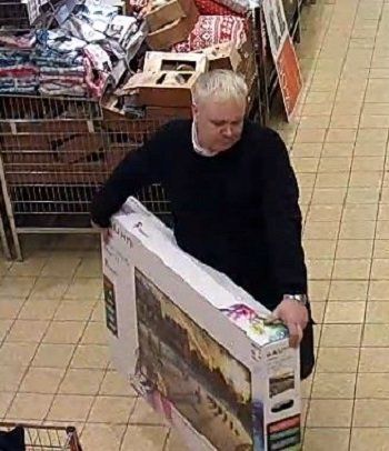 CCTV captured the man carrying a TV to the till 