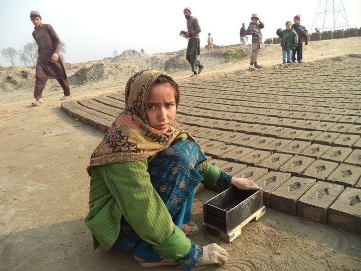 Qaseema, 8, started working at a brick kiln in Peshawar when she was 5 years old to help her father clear a debt that keeps growing.