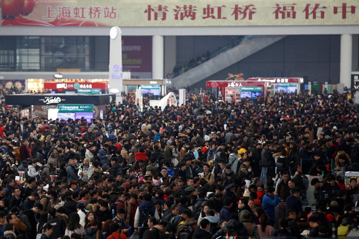 Passengers wait to board trains at Shanghai's Hongqiao Railway Station as hundreds of millions of Chinese travel home for Lun