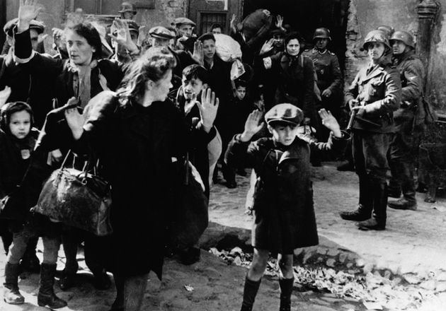 Jewish families surrender to Nazi soldiers in the Warsaw Ghetto in 1943.