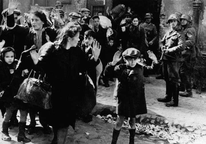 Frightened Jewish families surrender to Nazi soldiers at the Warsaw Ghetto in 1943.