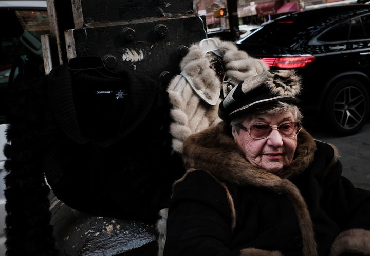 A woman sells fur jackets along a street in Brighton Beach, one of the largest Russian speaking enclaves in the Western Hemis