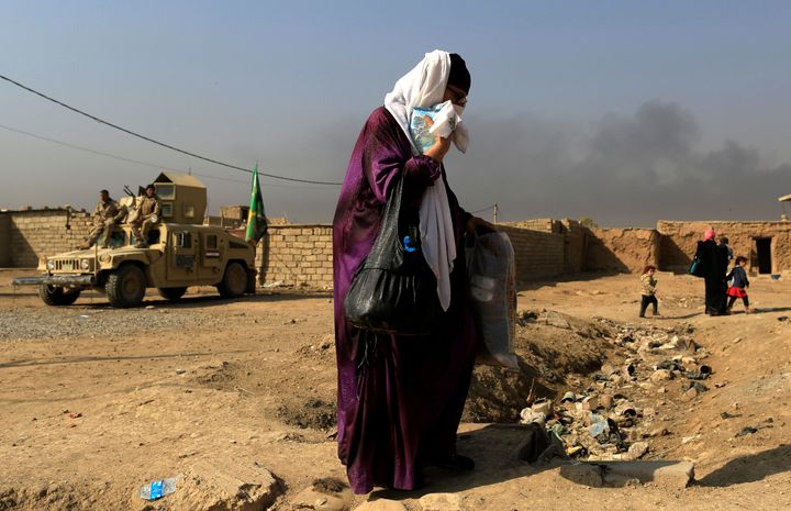 A woman who is fleeing the fighting between Islamic State and the Iraqi army in Mosul heads to safer territory in Iraq on Nov. 7, 2016.