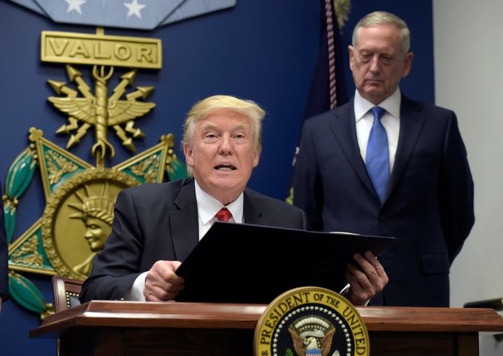 President Donald Trump, left, with Defense Secretary James Mattis, right, watching, explains the executive action on extreme vetting.