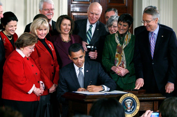 U.S. President Barack Obama signs the Lilly Ledbetter Fair Pay Act with Lilly Ledbetter of Alabama at his side in the East Room of the White House in Washington, January 29, 2009.