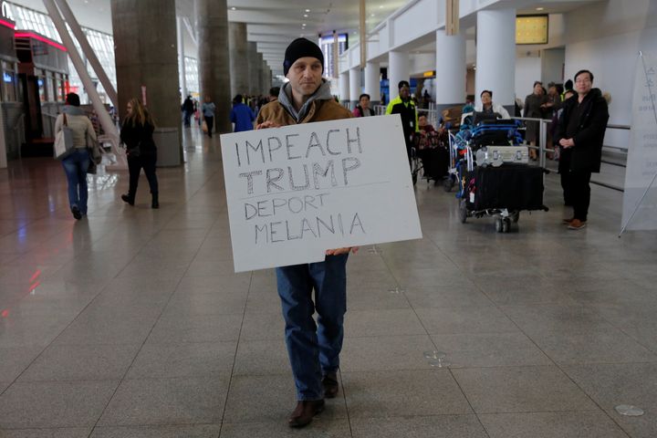 A protester walks through Terminal 4 at John F. Kennedy International Airport in Queens, New York, U.S., January 28.
