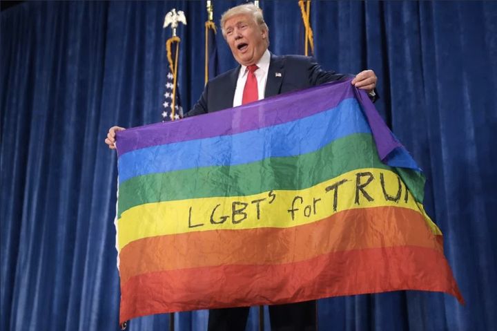 President Donald Trump holding the LGBT flag. 