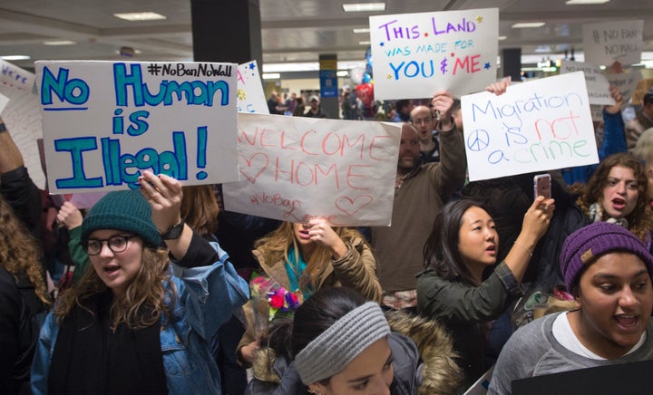 People gather at the international arrivals area of Washington Dulles International Airport on Jan. 28 to show their support for immigrants and refugees.