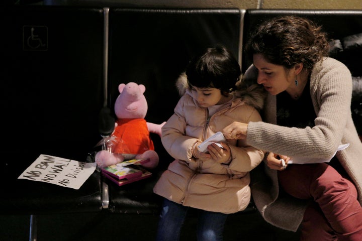 Traveler Hamad Bay's family waits for him at Boston's Logan Airport after he was taken away for questioning.