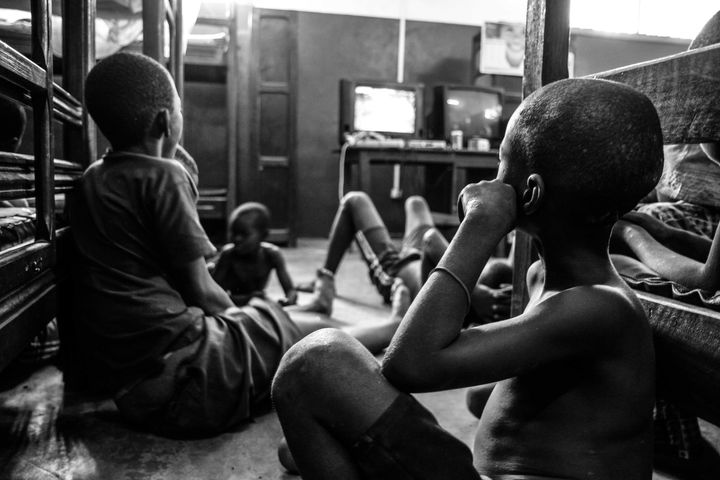 <p>Kids, rescued from the streets of Bangui, watch a Nigerian soap opera in their dorm room.</p>