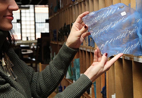 <p><strong>Each piece of glass is cataloged and stored vertically in wooden shelves.</strong></p>