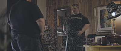 Tom (Merrick Robison) checks himself out in the mirror in a scene from <em><strong>Empty Space</strong></em>