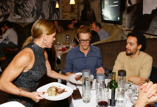 <p>Chef Cat Cora serving actor Kevin Bacon</p>