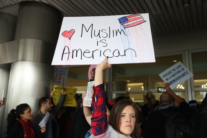 Tristan Houghton protests at Miami International Airport Sunday.