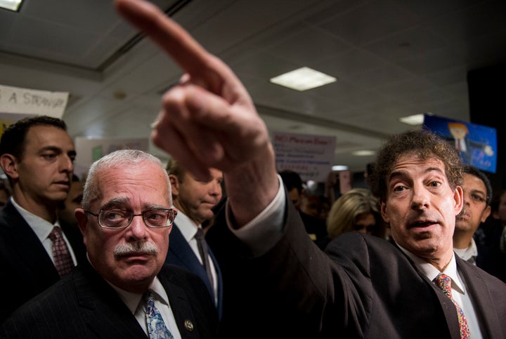 Rep. Gerry Connolly (D-Va.) and Rep. Jamie Raskin (D-Md.) speak to the press and protesters at Dulles International Airport in Virginia on Sunday.