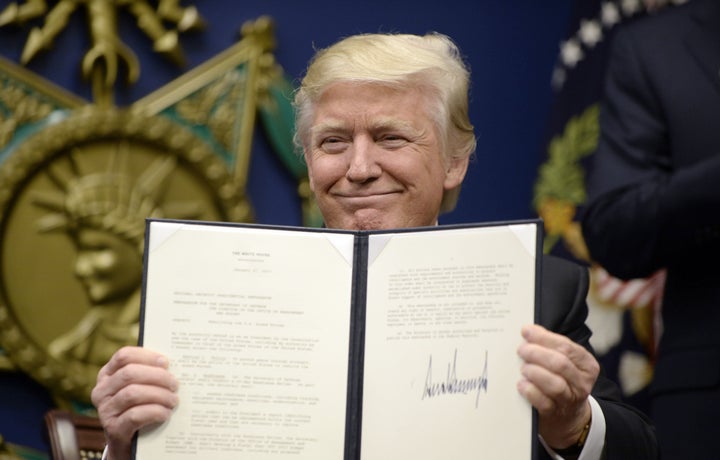 President Donald Trump holds up a signed executive order in the Hall of Heroes at the Department of Defense on Jan. 27.