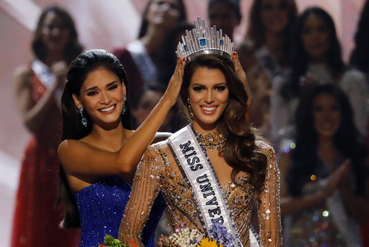 Pia Wurtzbach, left, places the crown on Miss France Iris Mittenaere after the latter was declared winner in the Miss Universe beauty pageant on Monday.