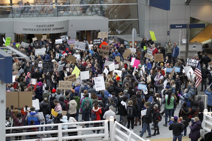 Activists gather at Portland International Airport to protest against President Donald Trump's executive action travel ban.