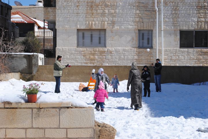 A Muslim family plays in the snow in Amman, Jordan. Nearly a sixth of Jordan’s population are now refugees, mostly from Syria and Iraq. 