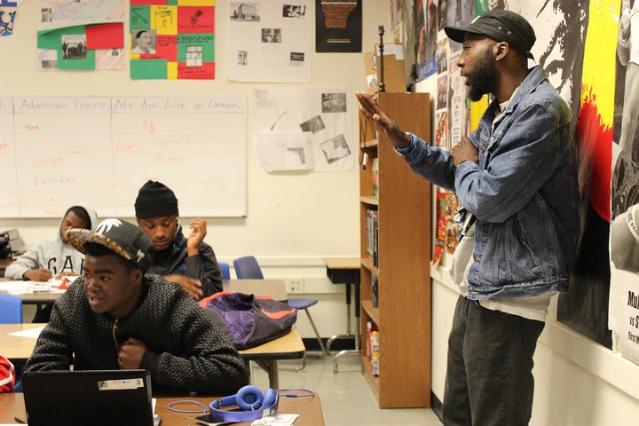 Teacher Earnest Jenkins III assists students with an assignment during his popular Manhood Development class at Oakland High School in Oakland, California. 