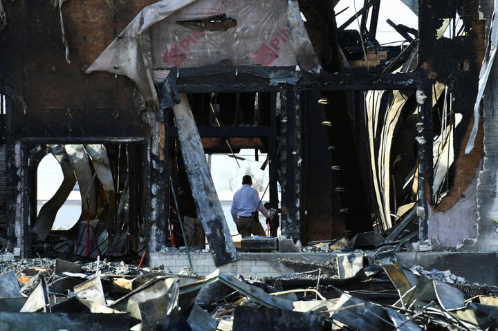 A security official investigates the aftermath of a fire at the Victoria Islamic Center mosque in Victoria, Texas January 29,