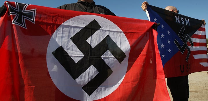 Members of the white supremacist National Socialist Movement hold swastika flags at an anti-immigration rally in Riverside, California, in 2009.