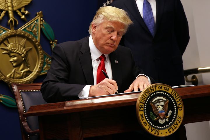 U.S. President Donald Trump signs an executive order to impose tighter vetting of travelers entering the United States, at the Pentagon on Jan. 27, 2017.