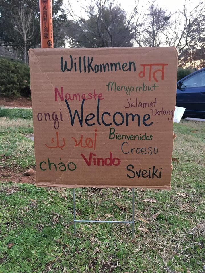 A multilingual sign carries a global message of welcoming.