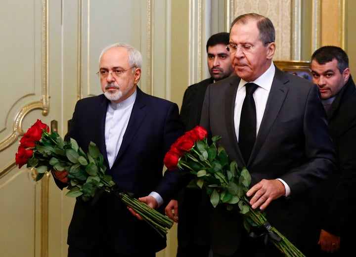 Russian Foreign Minister Sergei Lavrov and his Iranian counterpart Mohammad Javad Zarif lay flowers in front of a photo of a