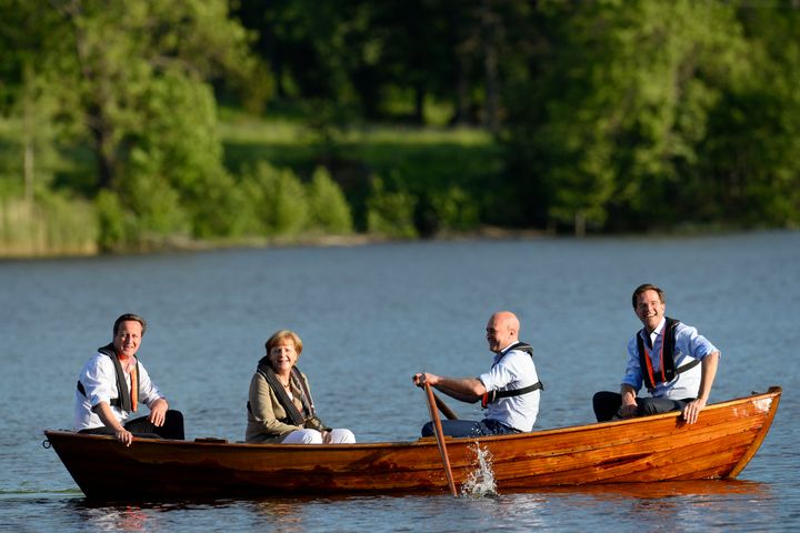 The sinking feeling: Cameron, Merkel and and Dutch Prime Minister Mark Rutte enjoy a spot of boating.
